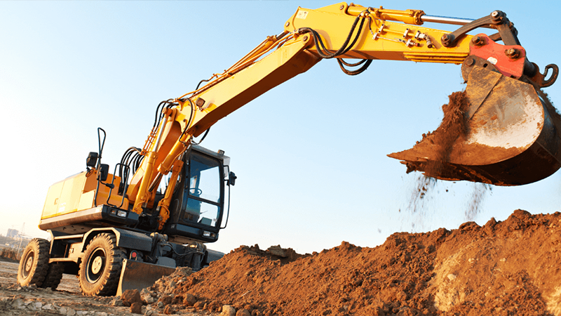 Excavator Removing Soil From A Construction Site During Excavation